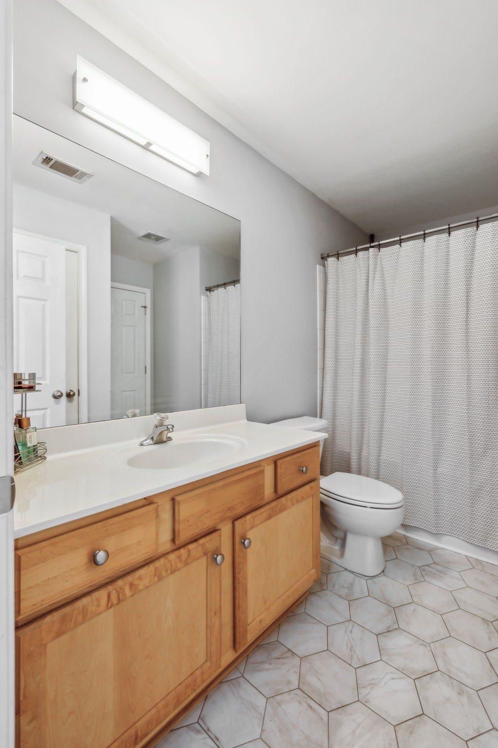 3535 Bell Road, Unit 301 Nashville, TN 37214 - Photo 31 of 47 a bathroom with a granite countertop sink a toilet and a mirror
