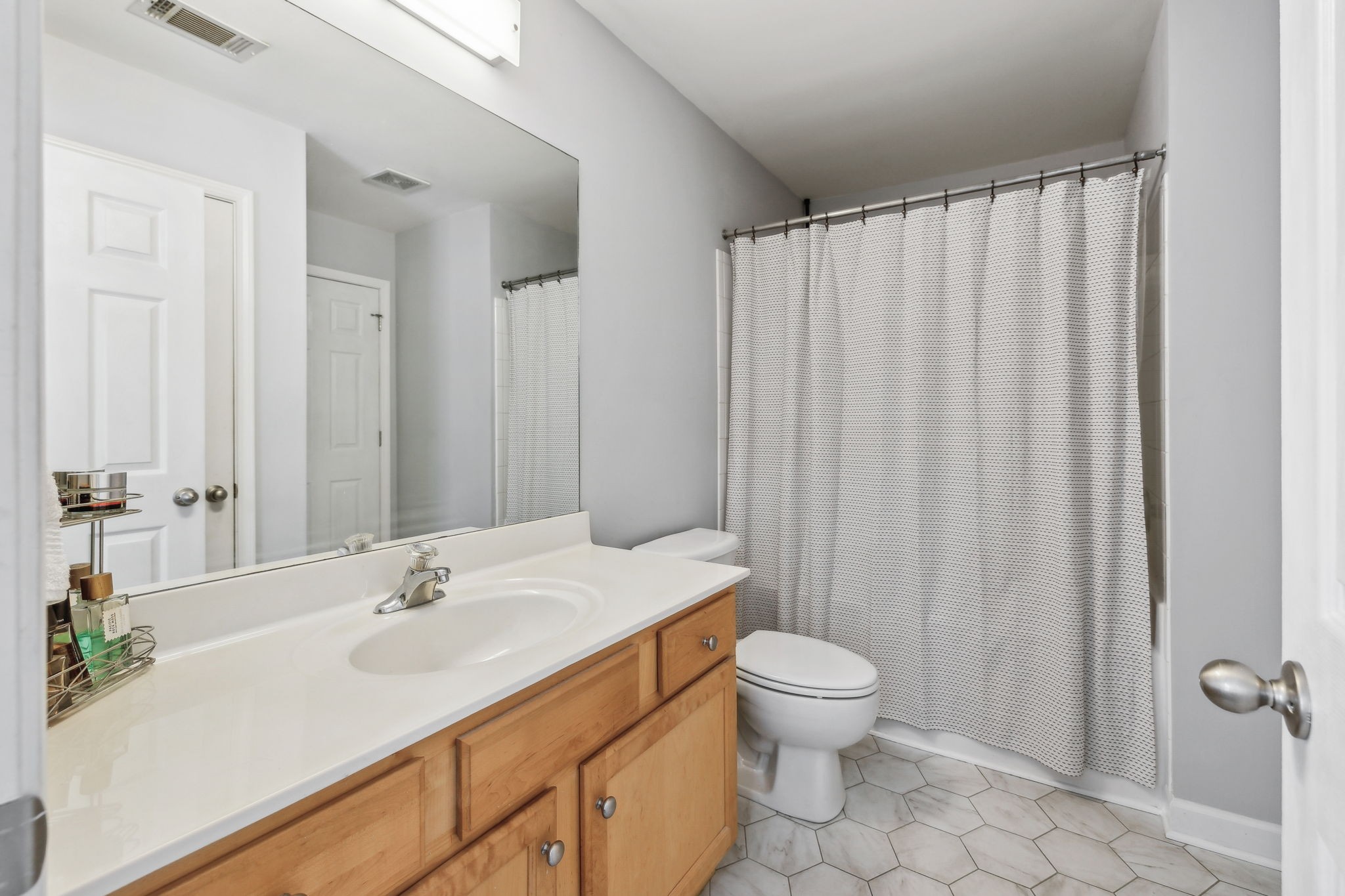 3535 Bell Road, Unit 301 Nashville, TN 37214 - Photo 32 of 47 a bathroom with a sink toilet a mirror and shower curtain