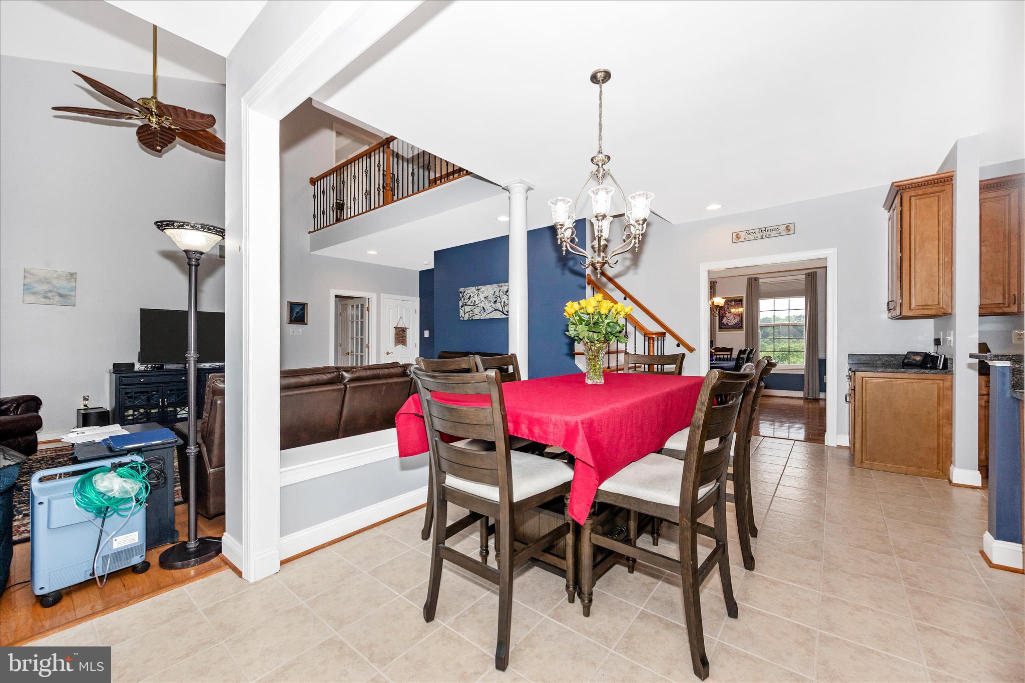 9855 McKinstry Mill Road New Windsor, MD 21776 - Photo 19 of 76 a view of a dining room and livingroom with furniture wooden floor a chandelier