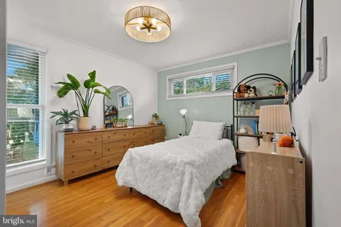 a bedroom with a bed and a dresser with mirror