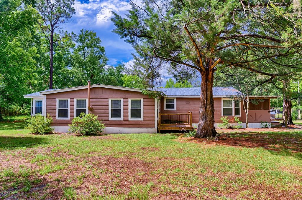 a front view of house with yard and green space