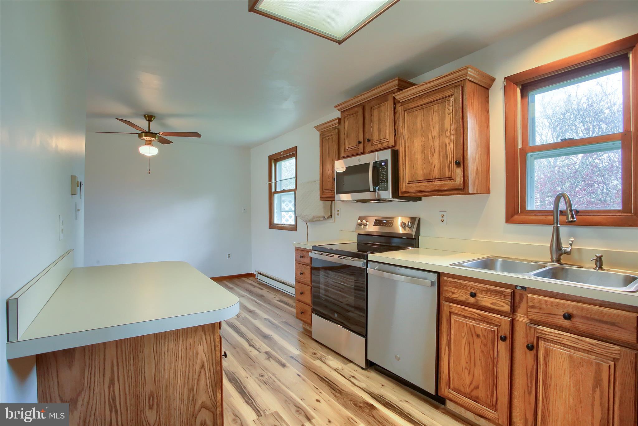 1916 Fisher Road Mechanicsburg, PA 17055 - Photo 12 of 31 a kitchen with stainless steel appliances a stove a sink dishwasher and a microwave oven with cabinets