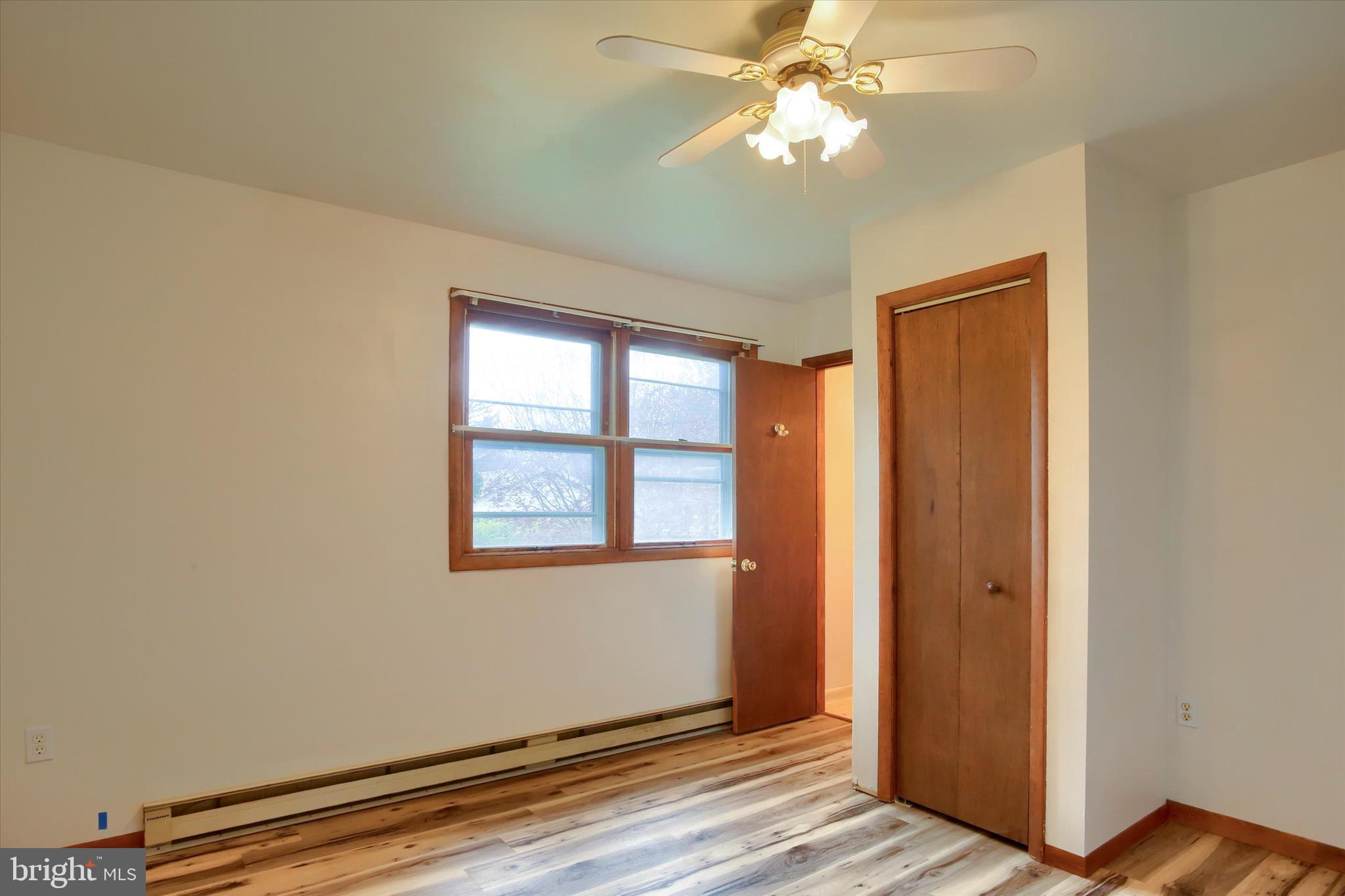 1916 Fisher Road Mechanicsburg, PA 17055 - Photo 13 of 31 a view of an empty room with wooden floor and a window