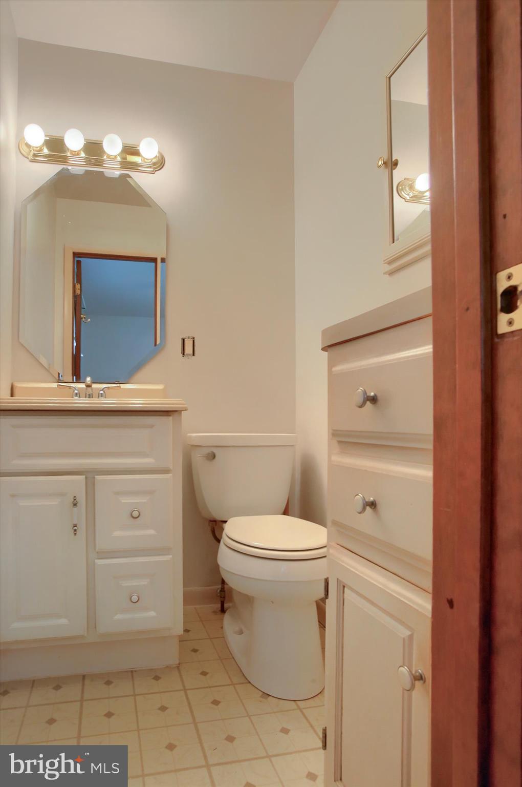 1916 Fisher Road Mechanicsburg, PA 17055 - Photo 15 of 31 a bathroom with a toilet a sink a vanity and mirror