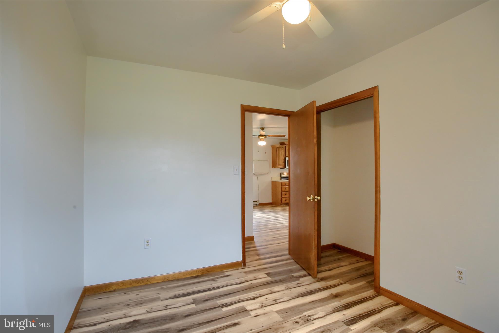 1916 Fisher Road Mechanicsburg, PA 17055 - Photo 20 of 31 a view of a room with wooden floor and a ceiling fan