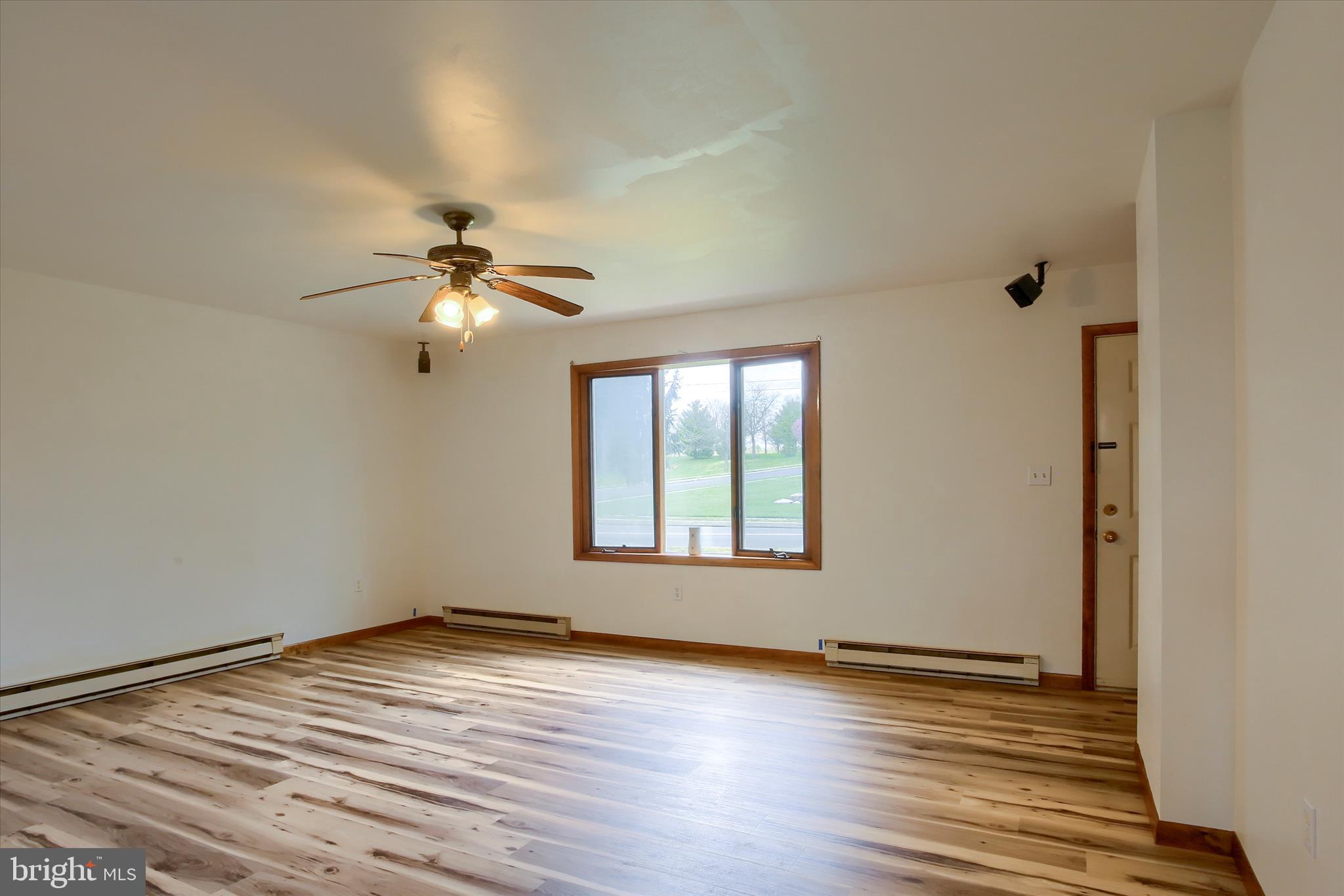 1916 Fisher Road Mechanicsburg, PA 17055 - Photo 6 of 31 a view of empty room with wooden floor and fan