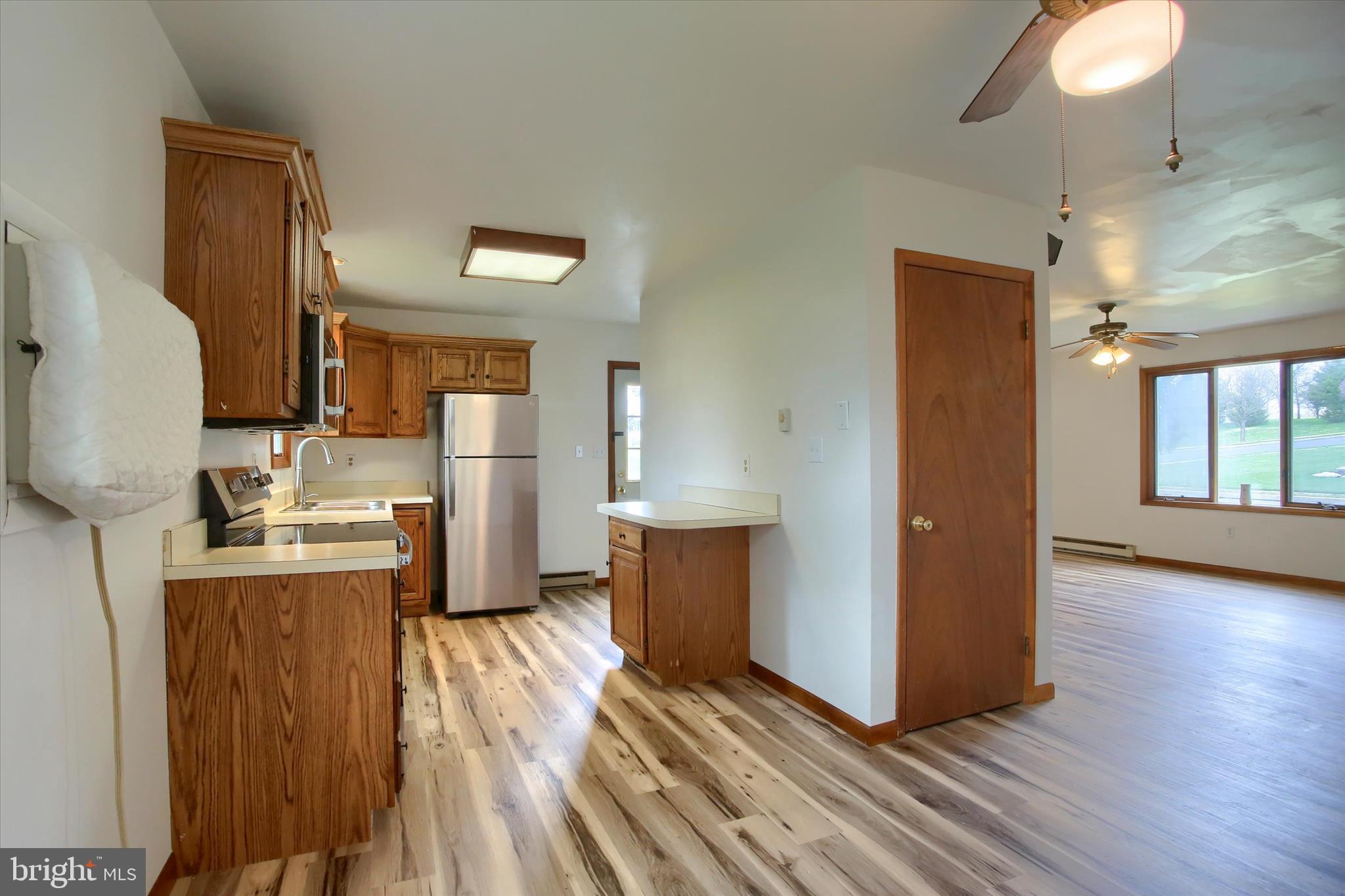 1916 Fisher Road Mechanicsburg, PA 17055 - Photo 10 of 31 a kitchen with stainless steel appliances granite countertop a refrigerator a stove and a wooden floors