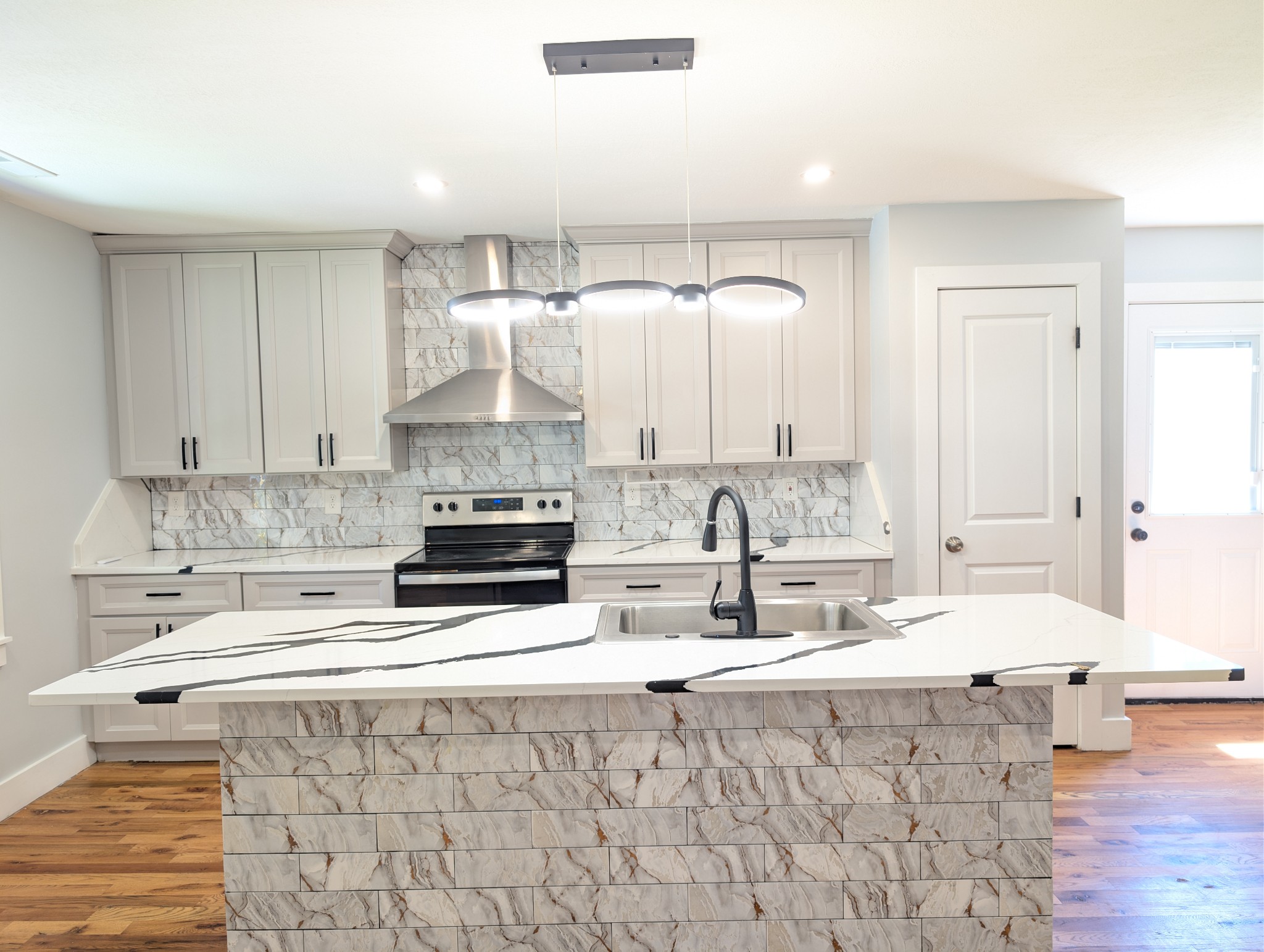 244 Warrior Road Madison, TN 37115 - Photo 4 of 24 a kitchen with stainless steel appliances a stove a sink and white cabinets