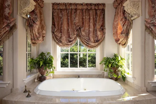 a bath tub sitting next to a window