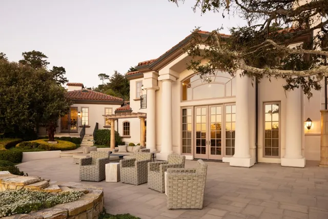 a front view of a house with outdoor seating