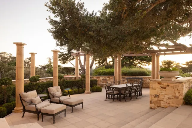 a view of a patio with a table chairs and a fire pit