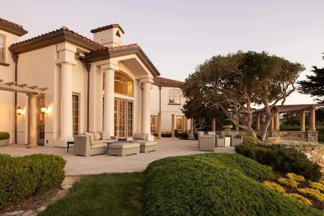 a front view of a house with a small yard and plants