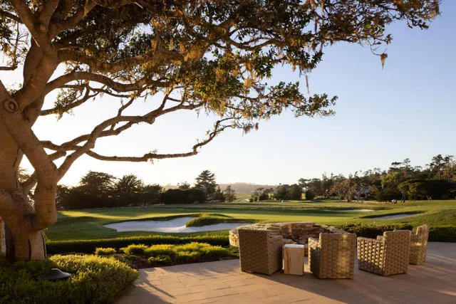 a view of lake with table and chairs under an umbrella