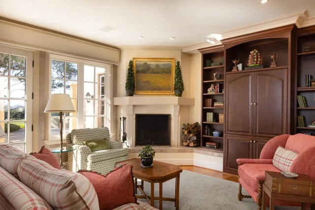 a living room with furniture a fireplace and a flat screen tv