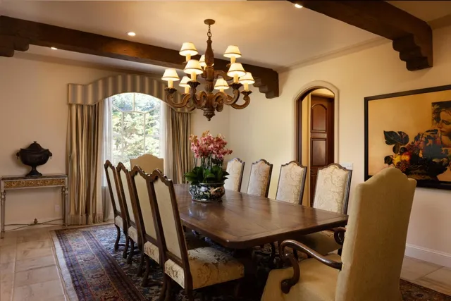 a view of a dining room with furniture and a chandelier