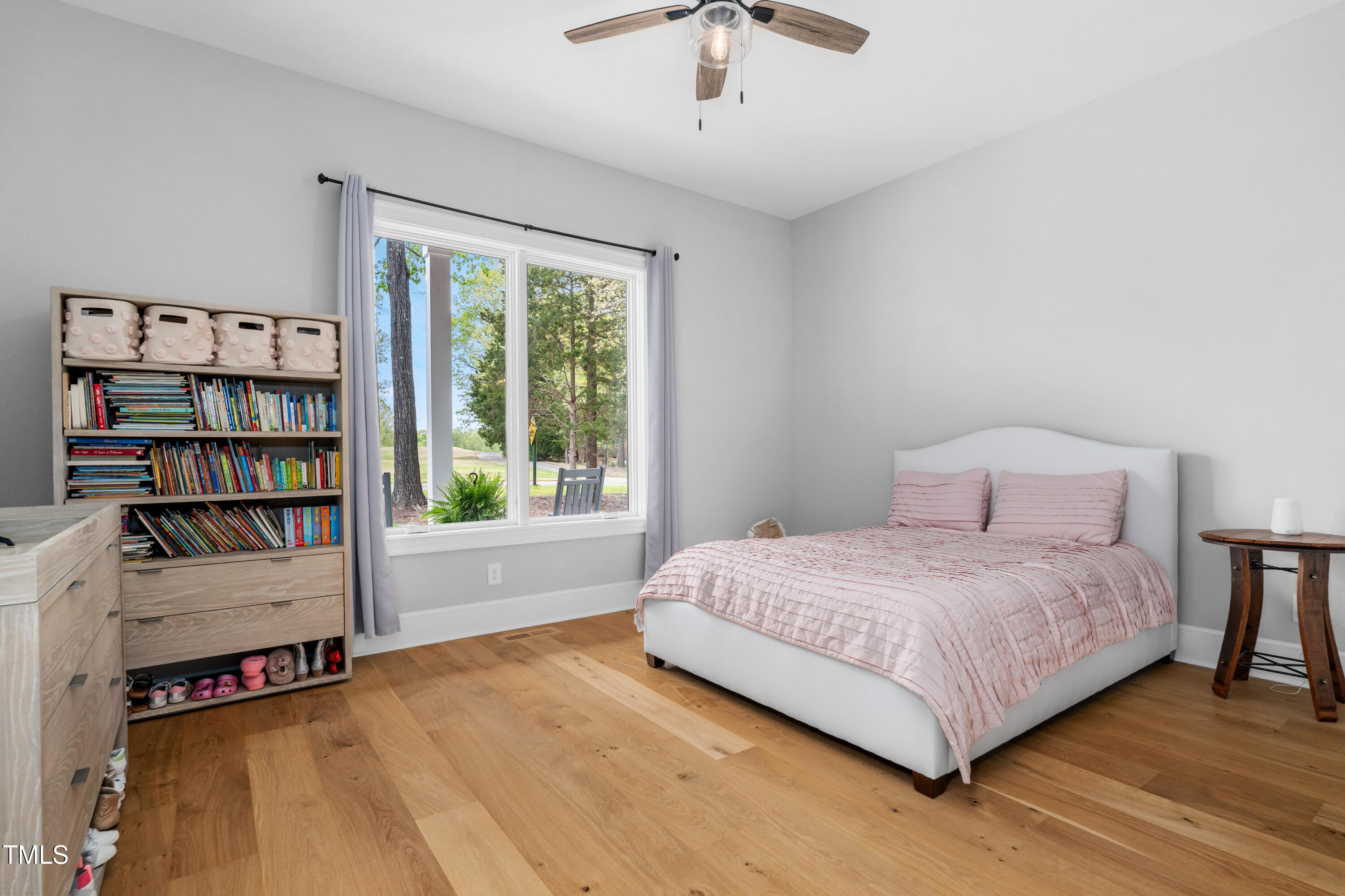 1213 Rocky Point Lane Durham, NC 27712 - Photo 29 of 76 a bedroom with a bed a book shelf and a window