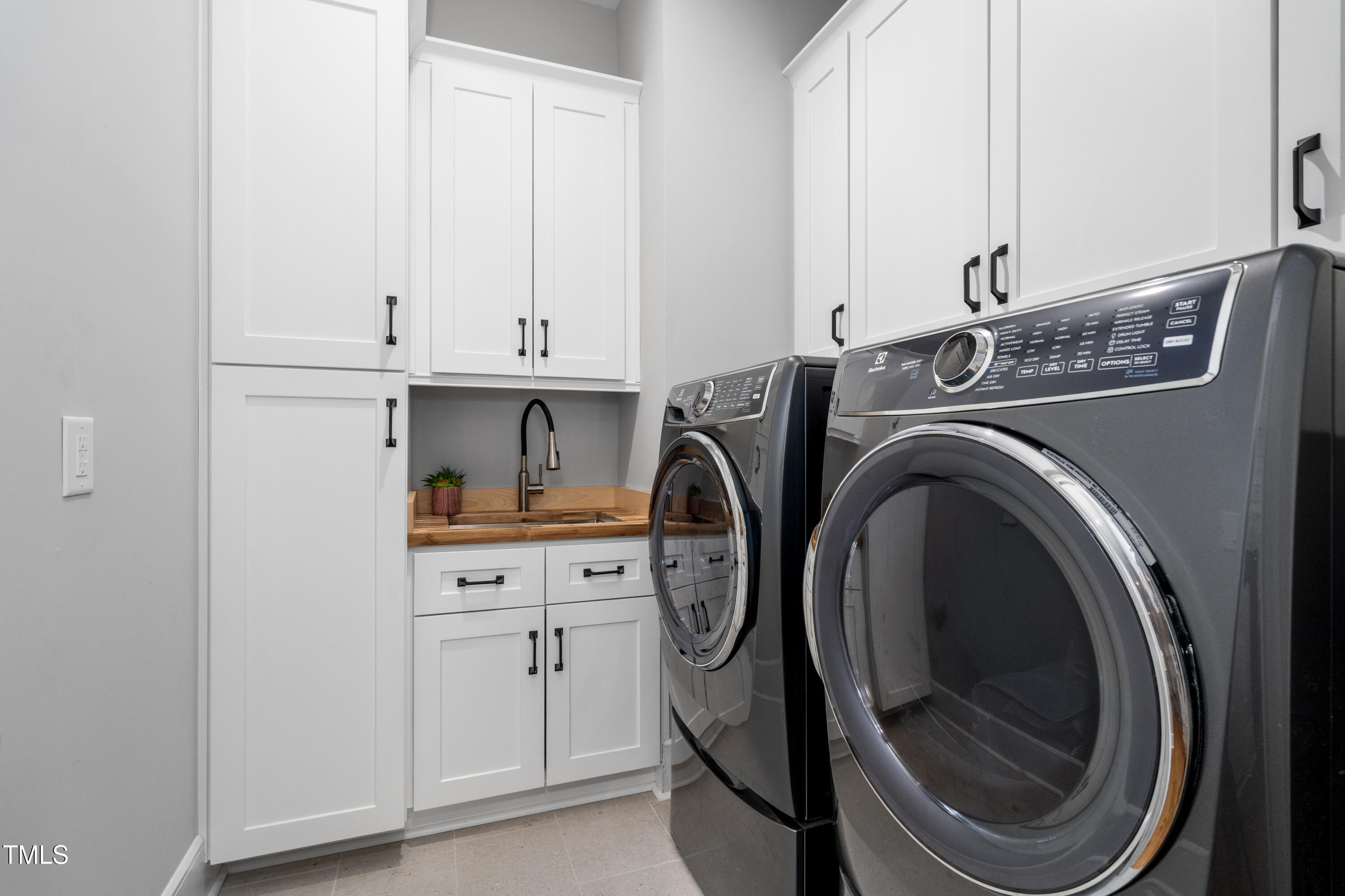 1213 Rocky Point Lane Durham, NC 27712 - Photo 45 of 76 a view of washer and dryer with kitchen in the background