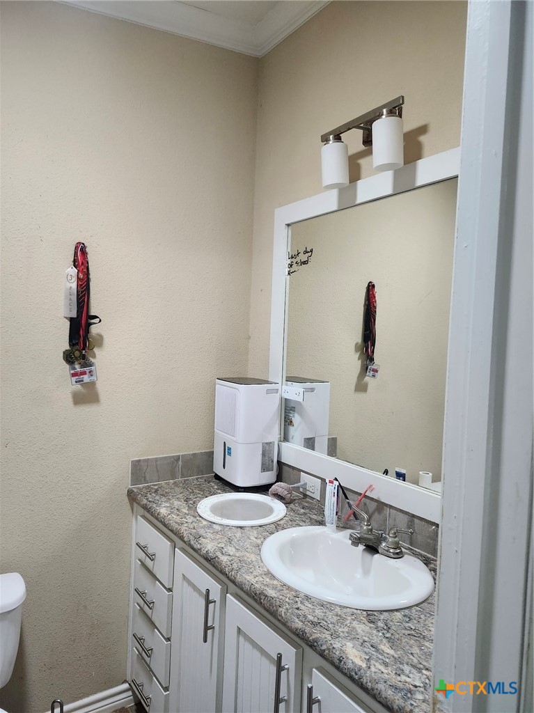 1845 Royal Road Port Lavaca, TX 77979 - Photo 10 of 22 a bathroom with a granite countertop sink and a mirror
