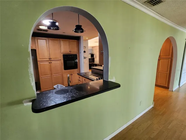 a view of backyard with a deck and wooden floor