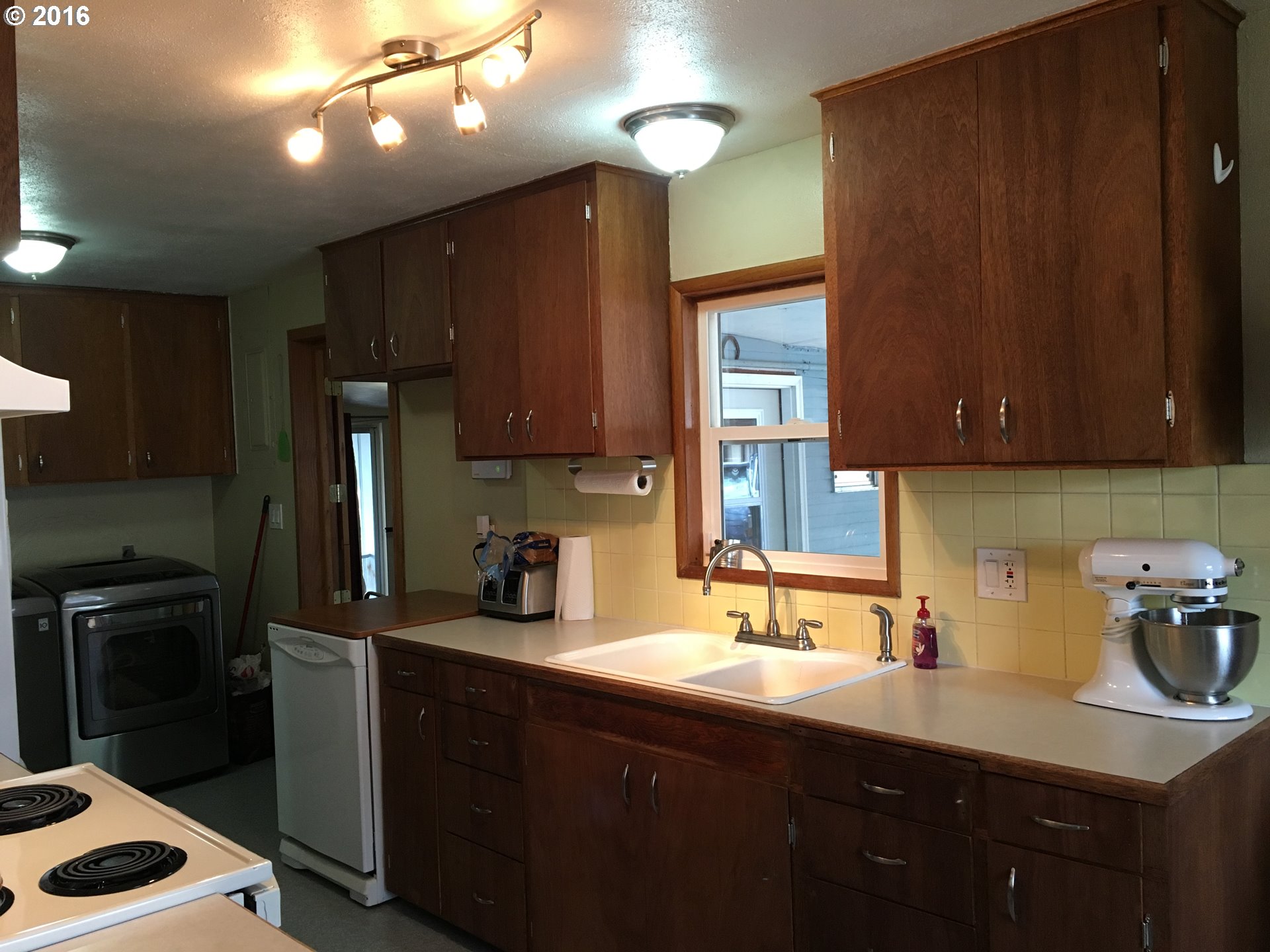 3311 Northeast Riverside Avenue Pendleton, OR 97801 - Photo 4 of 13 a kitchen with a sink a refrigerator and cabinets