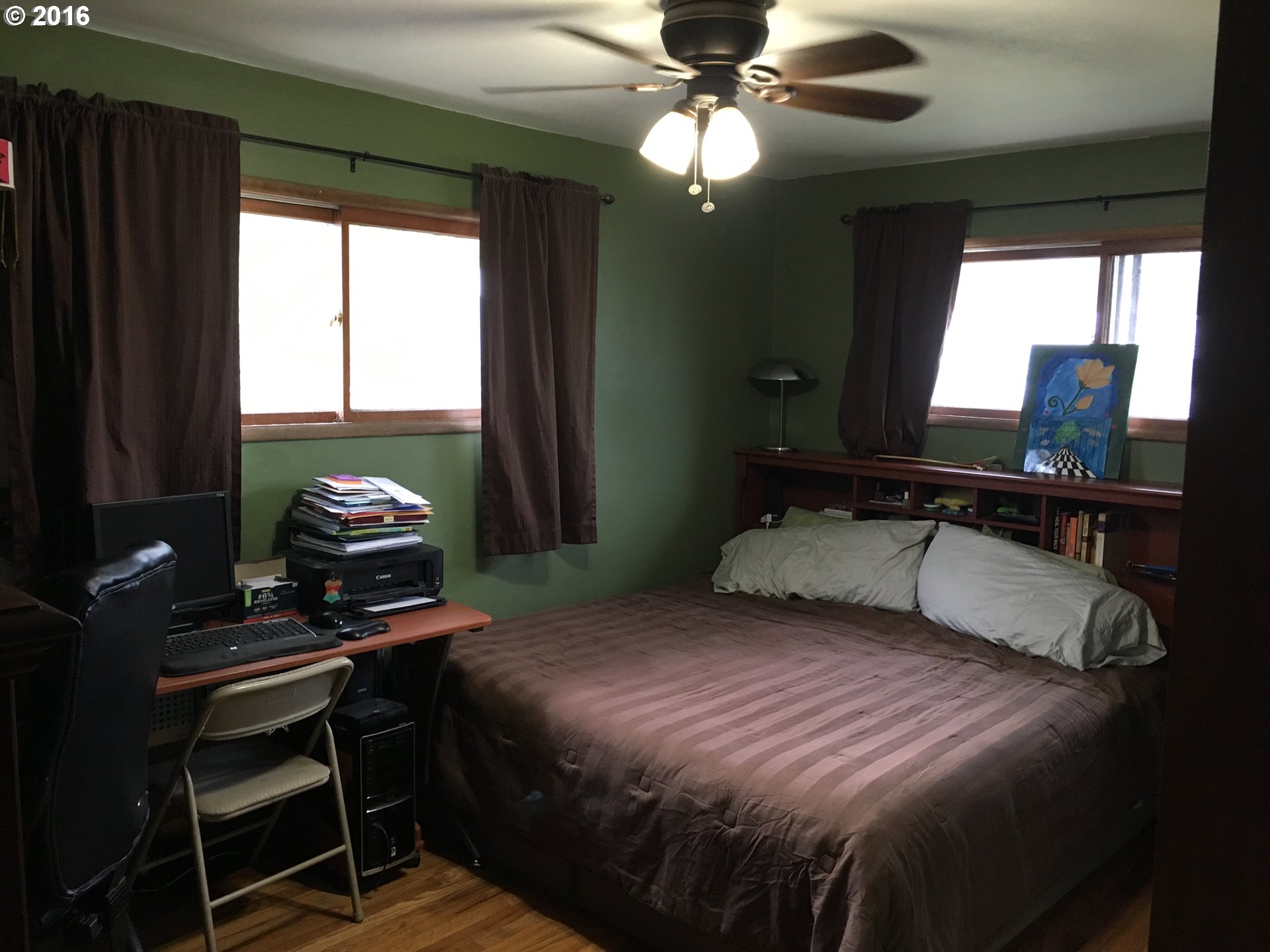3311 Northeast Riverside Avenue Pendleton, OR 97801 - Photo 7 of 13 a bedroom with a bed and a chandelier