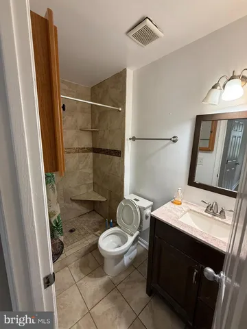 a bathroom with a toilet a sink and a mirror