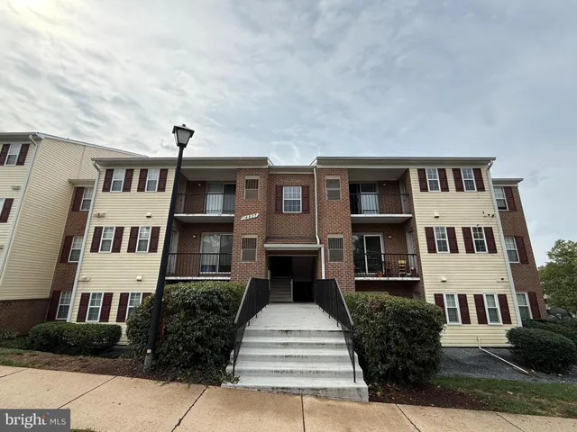 a front view of a building with a garden