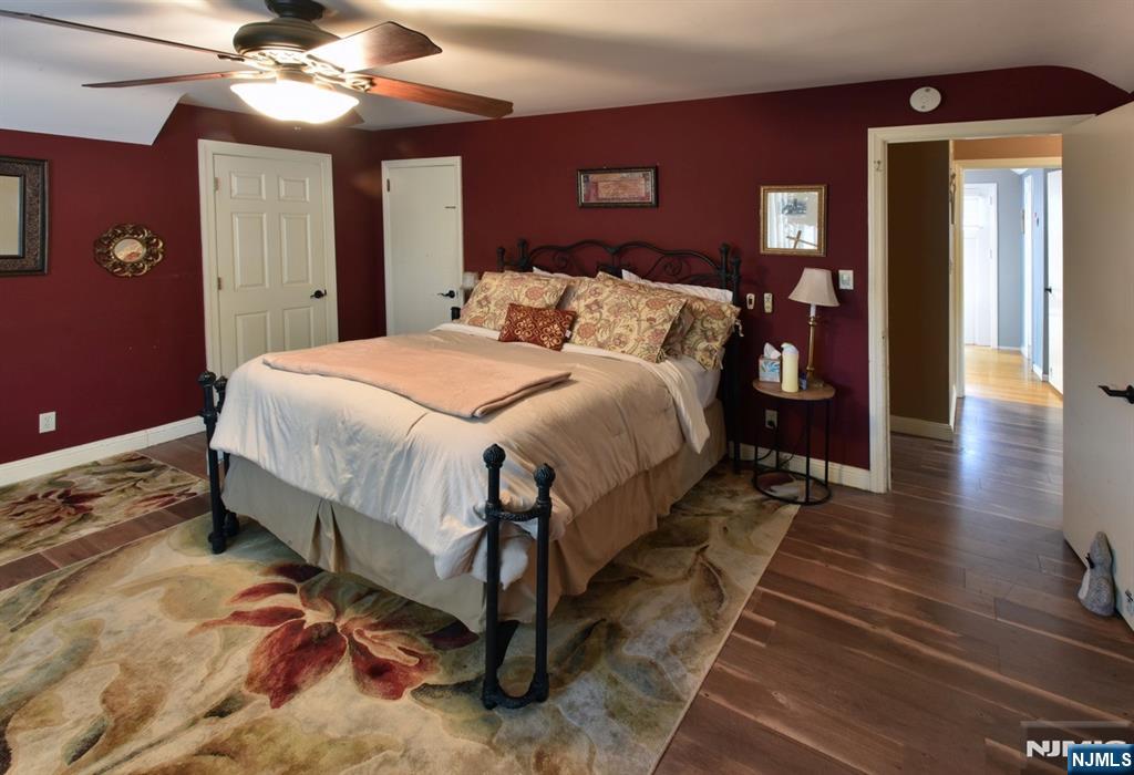 585 Monroe Place Ridgefield, NJ 07657 - Photo 13 of 28 a bedroom with a bed and a chandelier