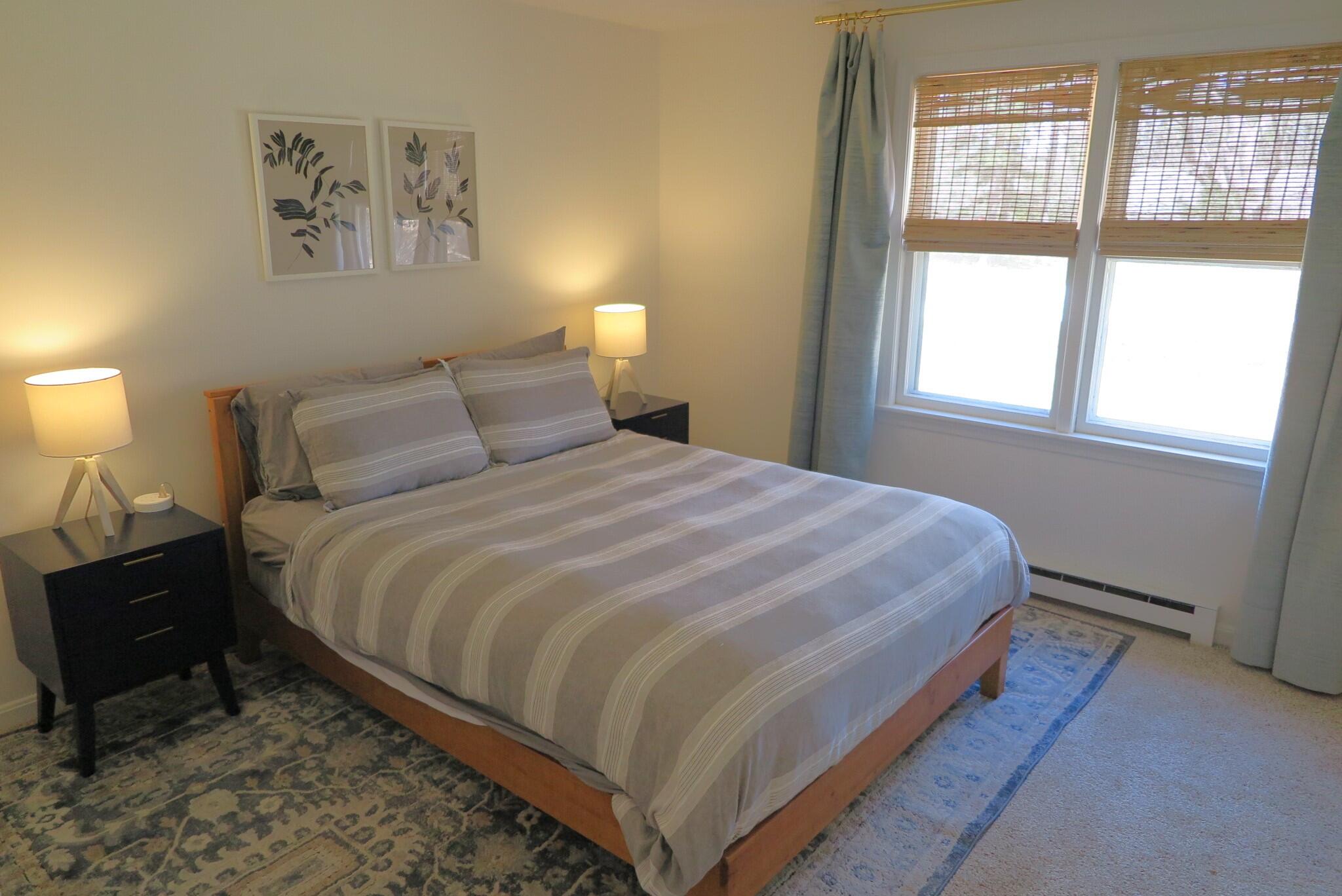 2420 Herring Brook Road Eastham, MA 02642 - Photo 15 of 37 a bedroom with a bed and a lamp on dresser