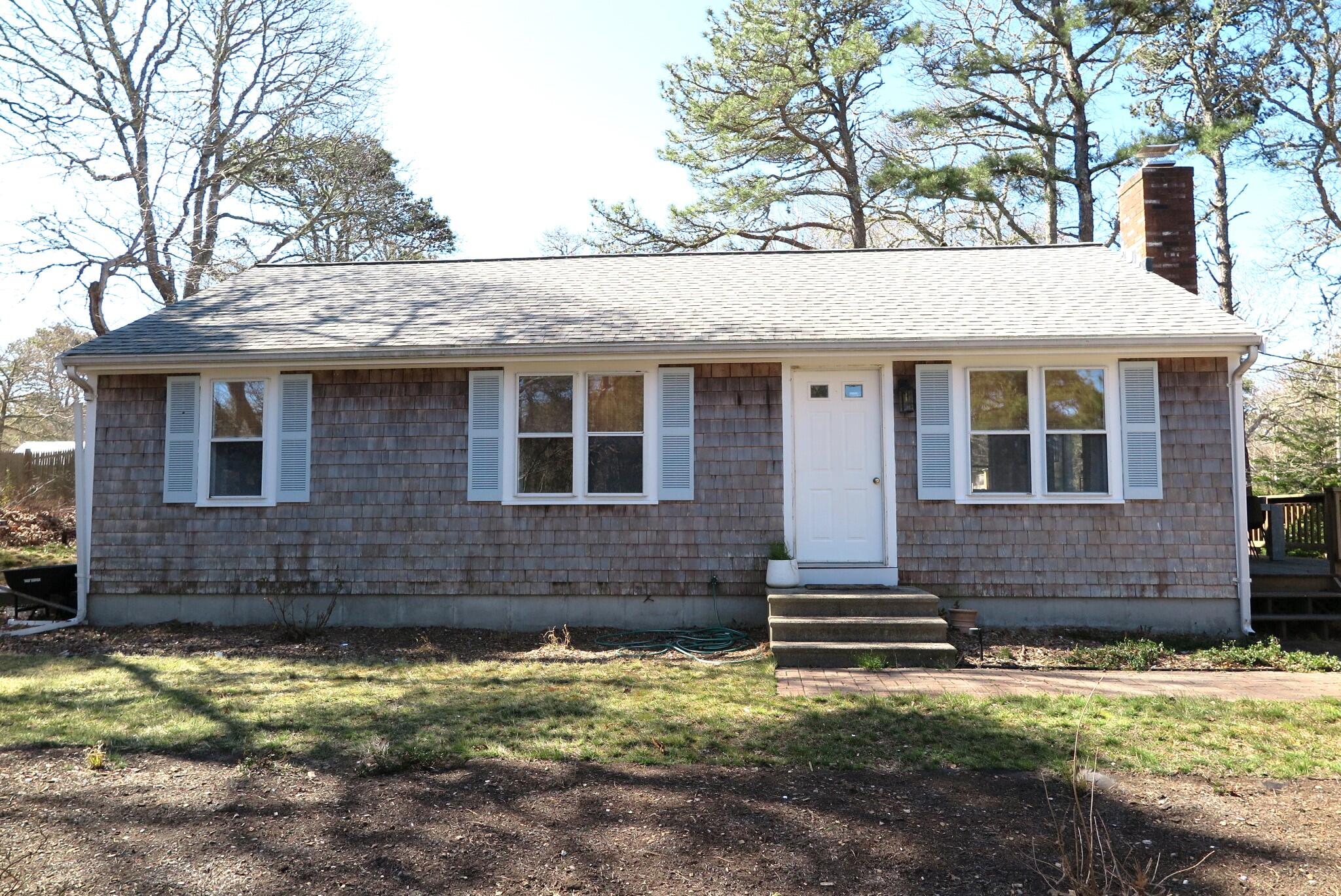 2420 Herring Brook Road Eastham, MA 02642 - Photo 21 of 37 a front view of a house with a yard