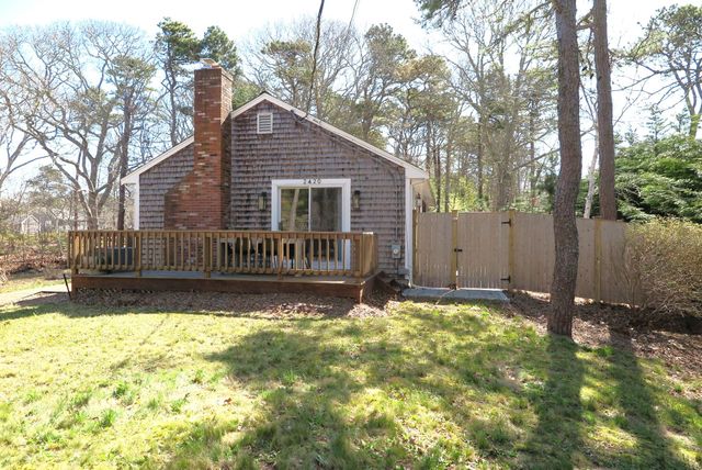 a view of a backyard with a large tree and a small yard