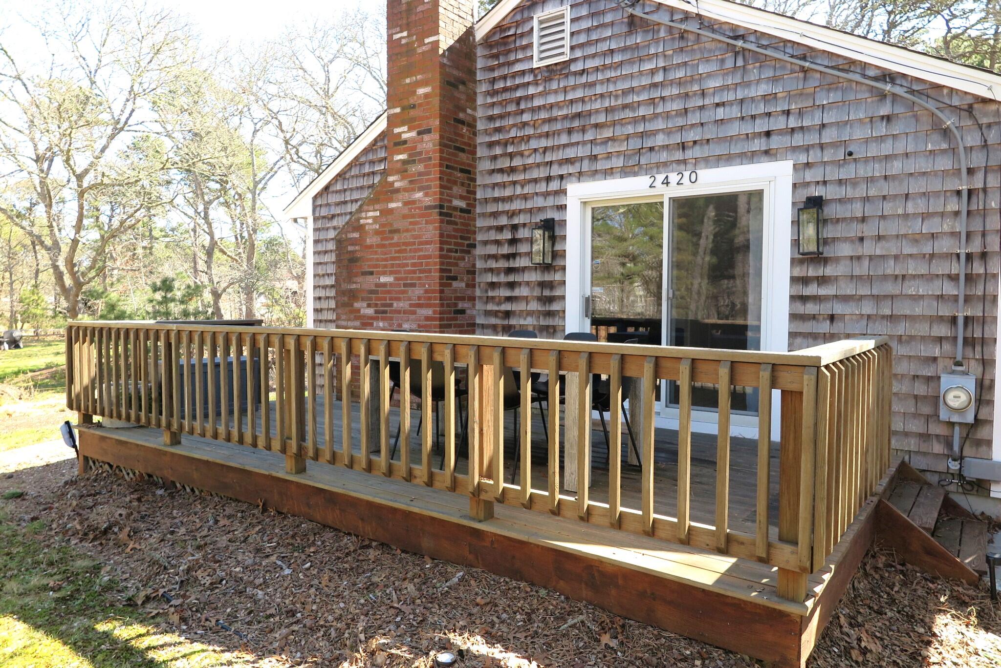 2420 Herring Brook Road Eastham, MA 02642 - Photo 25 of 37 a front view of a house with a garden