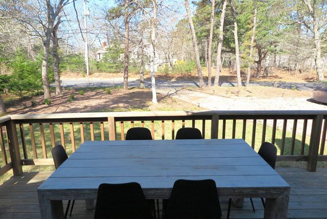 a view of a table and chairs on wooden deck