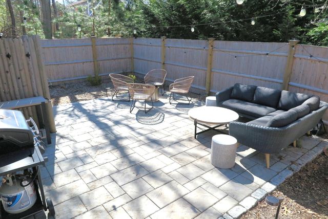 a view of a balcony dining table and chairs with wooden floor