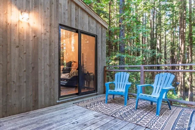 a view of a deck with wooden floor and outdoor seating