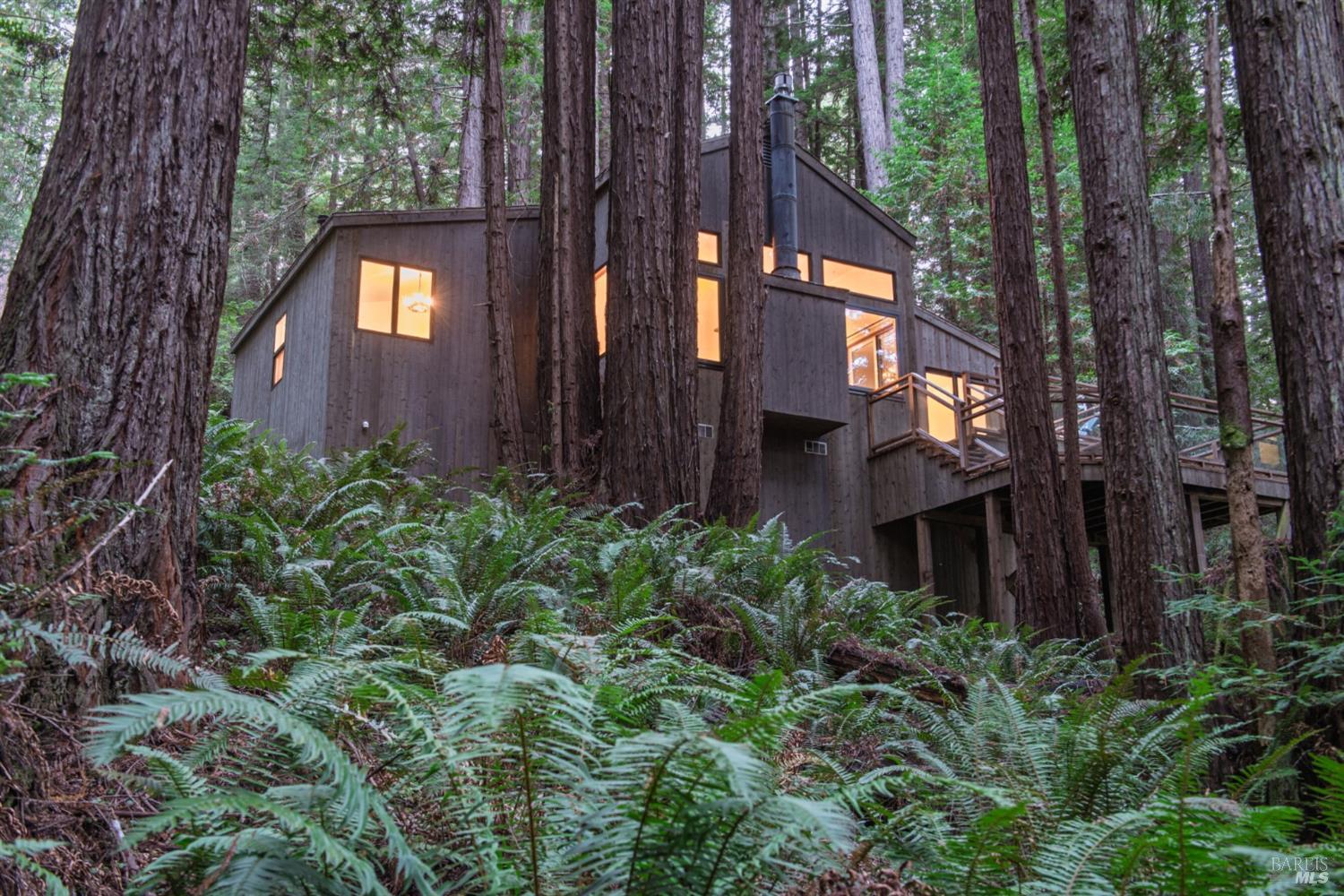 1101 River Beach Road The Sea Ranch, CA 95497 - Photo 4 of 34 a view of a brick house with a small yard and large tree