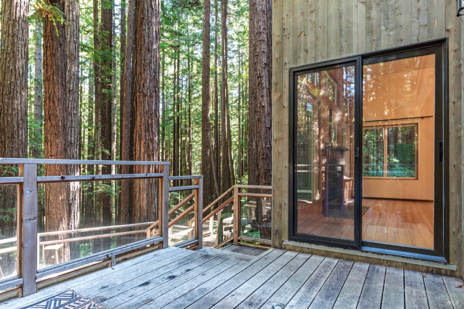 1101 River Beach Road The Sea Ranch, CA 95497 - Photo 5 of 34 a view of a balcony with floor to ceiling windows with wooden floor