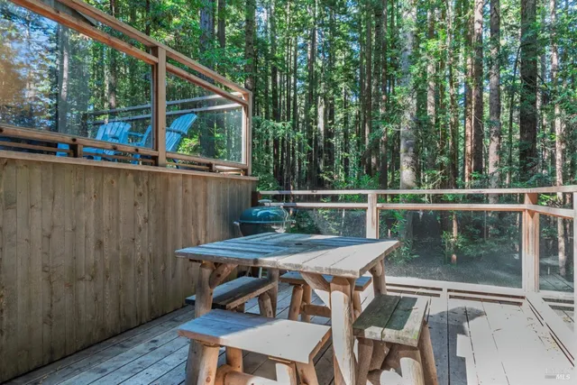 a patio with wooden floor and outdoor seating