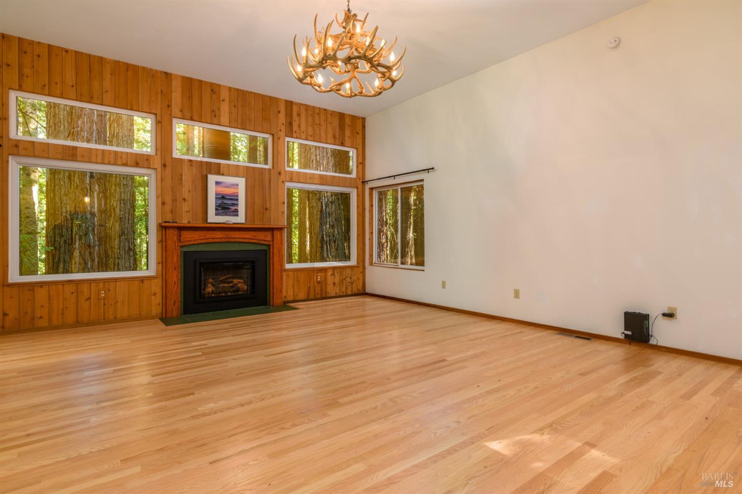 1101 River Beach Road The Sea Ranch, CA 95497 - Photo 9 of 34 a view of an empty room with a fireplace and a window