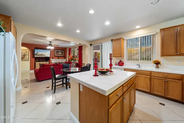 a kitchen with stainless steel appliances kitchen island granite countertop a sink and cabinets