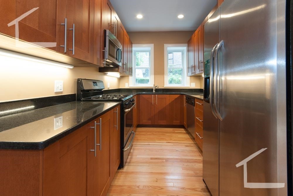 6 Lothian Road, Unit 1A Boston, MA 02135 - Photo 1 of 9 a kitchen with stainless steel appliances granite countertop a sink a stove and a refrigerator