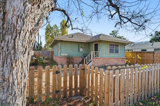 a front view of house with a garden
