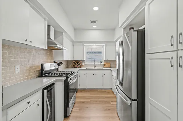 a kitchen with a refrigerator stove and sink