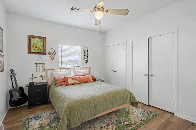 a bedroom with a bed and wooden floor