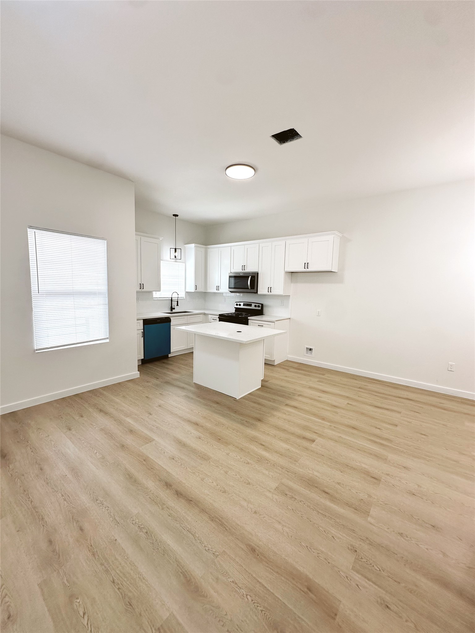 9707 Cargill Street Houston, TX 77029 - Photo 5 of 22 a kitchen with stainless steel appliances a refrigerator sink and microwave