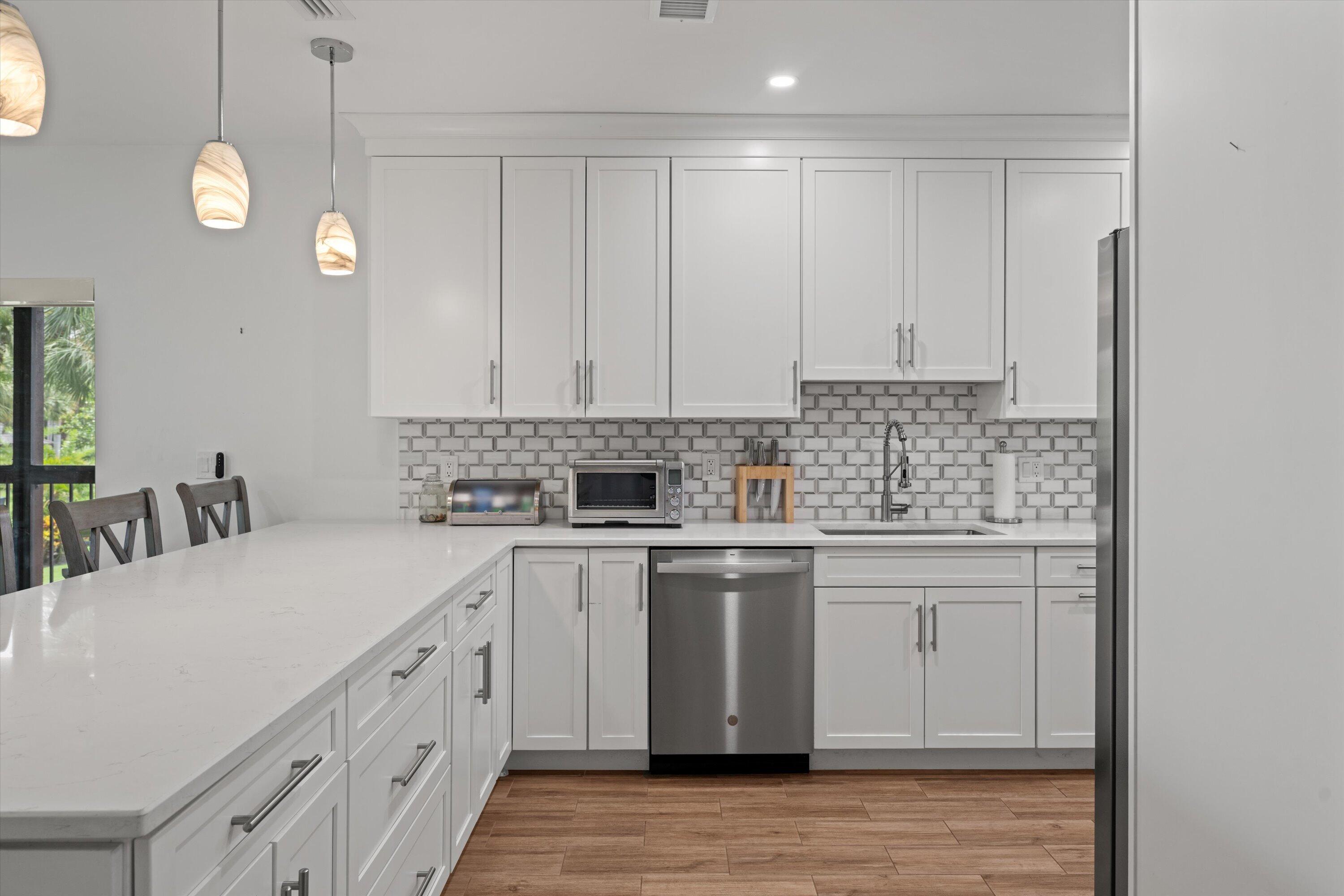13400 Polo Road West, Unit 203 Wellington, FL 33414 - Photo 10 of 26 a kitchen with a sink cabinets and window