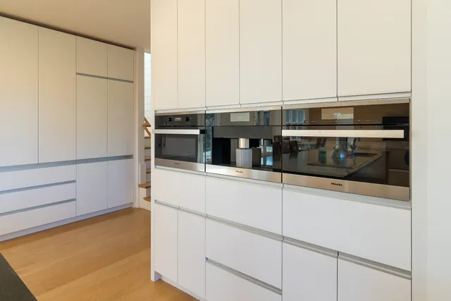 a kitchen with stainless steel appliances a sink and a refrigerator