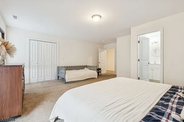 a spacious bedroom with a bed and a couch