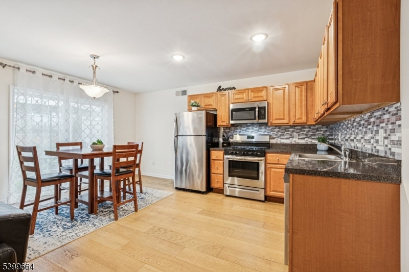 18 Joseph Drive, Unit 18 Newton, NJ 07860 - Photo 8 of 24 a kitchen with stainless steel appliances kitchen island granite countertop a stove a sink a dining table and chairs