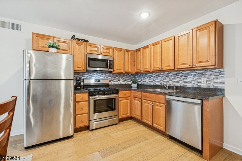 18 Joseph Drive, Unit 18 Newton, NJ 07860 - Photo 9 of 24 a kitchen with granite countertop a refrigerator stove top oven and sink